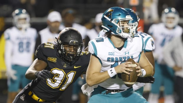 Oct 20, 2021; Boone, North Carolina, USA; Appalachian State Mountaineers linebacker Nick Hampton (31) catches Coastal Carolina Chanticleers quarterback Grayson McCall (10) and sacks him during the second half at Kidd Brewer Stadium. Mandatory Credit: Reinhold Matay-USA TODAY Sports